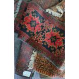 Five Persian style rugs four red and one terracotta colour.