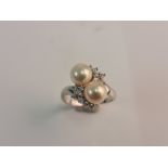 A stamped 585 pearl and diamond twist style ring, ring size M, appro. weight 4.7gms