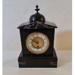 A black slate mantle clock with finial to top