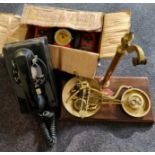 A bell system telephone Mettype junior and a set of brass scales.