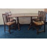 A solid mahogany double pedestal dining table with one leaf and four oak chairs.