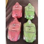 Four Sadler racing car teapots two pink and two green.