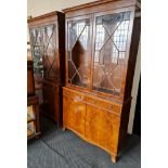 Two yew wood display bookcase with two glazed doors to top and cupboard bases.