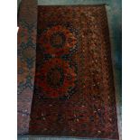 A large dark red Persian style rug.