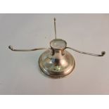 A hallmarked silver circular stand, with central holder approx. diameter 10cms, approx. height 8 cms