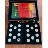 A case containing a collection of Chinese stamps coins pocket watch media’s.