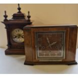 A walnut cased Westminster chiming clock together with a walnut cased mantle clock with carved
