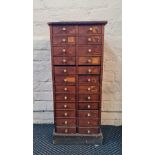 A twenty four drawer narrow chest.