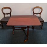 A 19th century mahogany Sutherland table with a set of four balloon back dining chairs