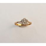 A 9ct gold six stone diamond ring set in a floral design.