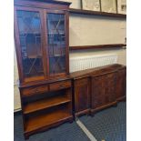 A mahogany reproduction bookcase with breakfront sideboard.