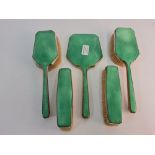 An Art Deco style green dressing table set, comprising of two hair brushes, mirror, and two