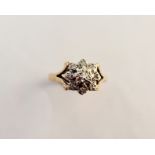 A 9ct gold ring set with nine diamonds in a floral set.