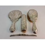 A hallmarked silver Art Noveau dressing table set, comprising of a hand mirror, hair brush,