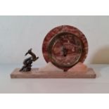 A marble Art Deco mantle clock with round face and metal deer to side. 23 cm 40 cm.