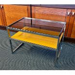 A Mda Howard Miller chrome framed coffee table with glass top and shelf.