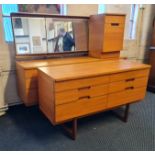 A teak dressing table with triple mirror six drawer chest and bedside cabinet.