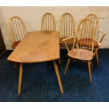 An Ercol elm sideboard drop leaf table and a set of six stick back dining chairs one chair with