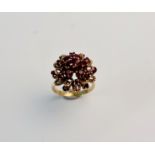 A stamped 585 tiered garnet cluster ring, ring Q1/2, approx. weight 6.4gms