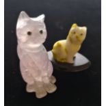 Two hand carved stone cat figures.