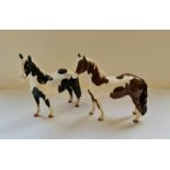 Two Beswick Pinto horses.