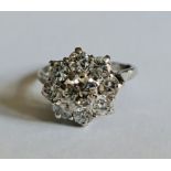 A hallmarked platinum diamond flower cluster ring, set with a principal round brilliant cut