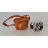 A small Click Camera in leather case.
