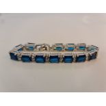 An articulated bracelet of 13 blue stones each one separated by double gem stones .approx. length