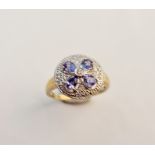A 18ct gold diamond and blue stone set fancy ring with central diamond surrounded by blue blue
