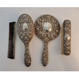 A patterned dressing table set, comprising of a hand mirror, hairbrush, clothes brush and comb,