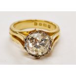 A hallmarked 18ct yellow gold diamond solitaire ring, set with a cushion cut diamond, measuring