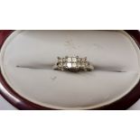 A diamond ring, set with three clusters of princess cut diamonds, total diamond weight approx. 0.