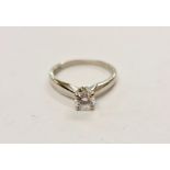 A hallmarked platinum diamond solitaire ring, set with a round brilliant cut diamond, measuring