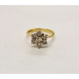 A hallmarked 18ct yellow gold diamond flower cluster ring, set with seven round brilliant cut