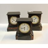 Three black slate and marble mantle clocks.