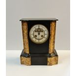 A black slate and marble visible escape movement mantle clock stamped LB 869 height 31 1/2 cm.