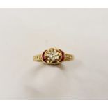 A yellow metal diamond ring surrounded by ruby accents, diamond accents to shoulders, ring size N
