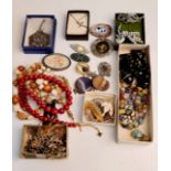 A quantity of costume jewellery to include, brooches, cross pendant on chain, beads,pendant etc