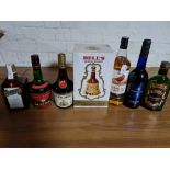 A boxed bottle of Bell's whisky, The Famous Grouse, bottle of Cointreau and four other bottles of