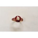 A stamped 14k ruby and diamond cluster ring, central diamond approx.1.00cts, surrounded by bagette
