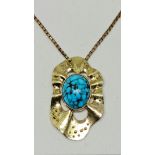 A turquoise pendant, set with an oval turquoise cabochon, measuring approx. 21x17mm, in an organic