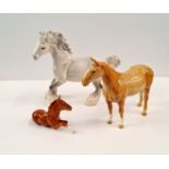 Three Beswick horses one rocking horse grey.