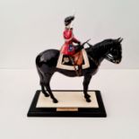 A Coalport figure Trooping the Colour on stand.