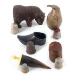 Five thimble cases and stands, each with a thimble, comprising a carved wood figure of a seated bear