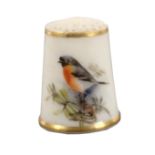 A puce mark Royal Worcester porcelain thimble, painted with a red breasted bird amid foliage between
