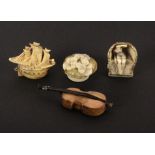 Four novelty celluloid tape measures, comprising an example as a galleon, 6cms, another as a