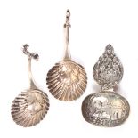 Three 19th Century Dutch silver caddy spoons, comprising a pair with leaf and shell bowls to curving