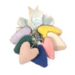 A 19th Century love token comprised of seven pin hearts, in various coloured silks all with original