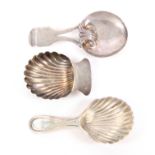 Three silver caddy spoons, comprising a shell bowl example with plain handle, unmarked, 5cms,