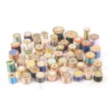 Fifty one wooden cotton and other reels, all with printed paper labels for individual shops and